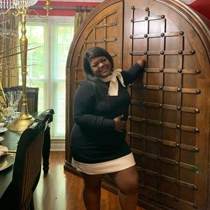 Black and cream dress with tie collar.